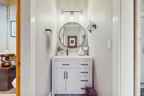 a bathroom with a white sink and a mirror at The Beach Suite in Langley