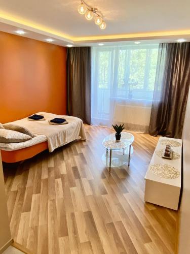 a bedroom with a large bed and a table at Cozy & comfortable place in city centre in Tartu