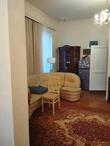 a living room with a couch and a chair at Barateli in Kutaisi