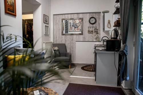 a living room with a table and a chair at Studio '98 Apartments broj 31 in Sisak