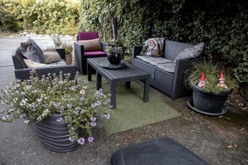 a patio with chairs and a table and flowers at Studio '98 Apartments broj 31 in Sisak