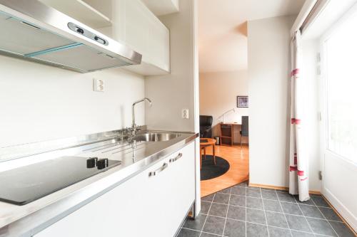 a kitchen with a sink and a counter top at Tynset Hotel in Tynset