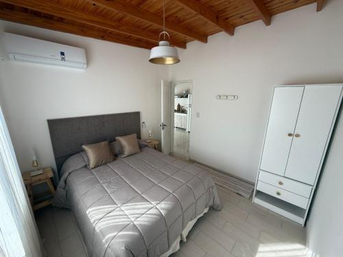 a bedroom with a bed and a white cabinet at Maschwitz Norte C in Ingeniero Maschwitz