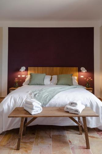 a bedroom with a large bed with towels on a table at Tenuta Tortorella Agriturismo in Altavilla Silentina