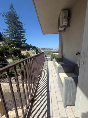 a balcony of a building with stairs and a tree at Vista sullo Stretto in Messina
