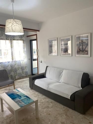 a living room with a couch and a table at Estocolmo Lovely in Gran Tarajal
