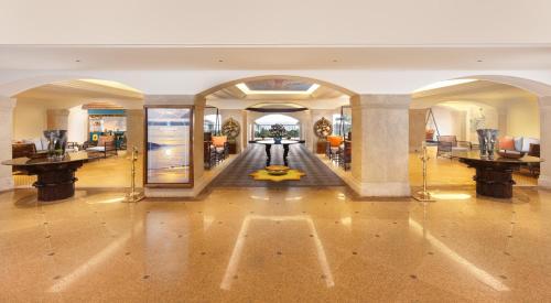 a large room with a lobby with tables and chairs at Gateway Varkala in Varkala