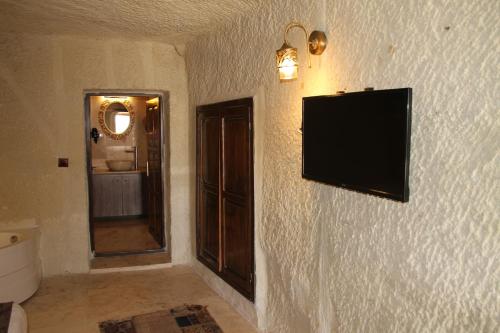 a flat screen tv on a wall in a bathroom at Zen Cappadocia House in Goreme