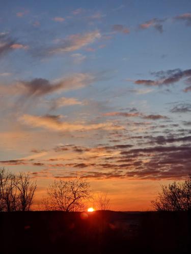 a sunset with the sun in the sky at La casita in Villefranque
