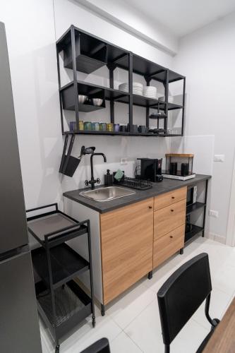 a kitchen with a sink and a counter at La Casa di Peppolo in Randazzo