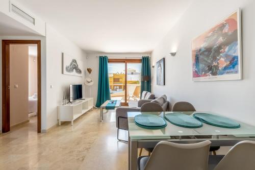 a living room and dining room with a table and chairs at Apartment Holiday Haven in Punta Prima