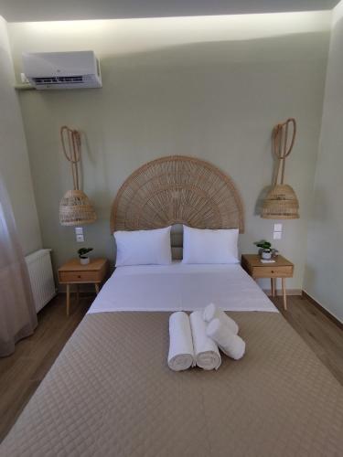 a bedroom with a bed with two towels on it at Casa Di Mario Rooms in Lávrion