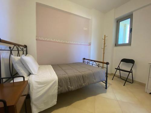 a bedroom with a bed and a desk and a chair at Coastal Horizon in Míloi