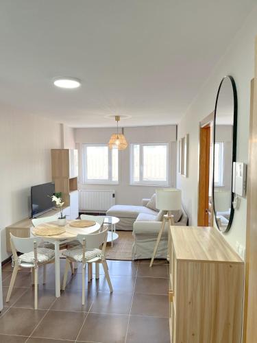 a living room with a table and a couch at Apartamento Son do Mar in Porto do Son