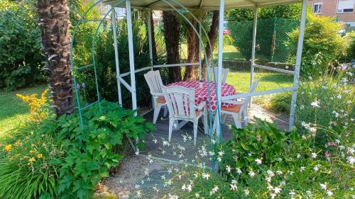 a table and chairs sitting under a gazebo at Casa Silvia in Germignaga