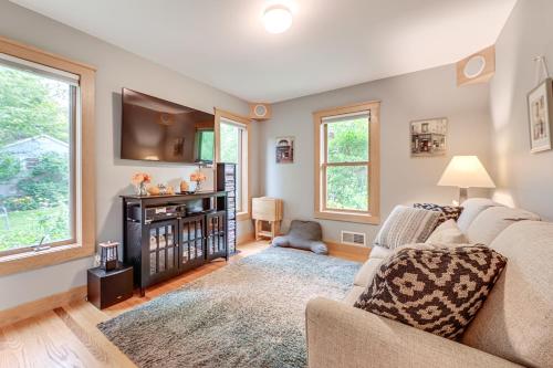 a living room with a couch and a tv at Finger Lakes Home with Private Pool and Lake Views! in Hammondsport