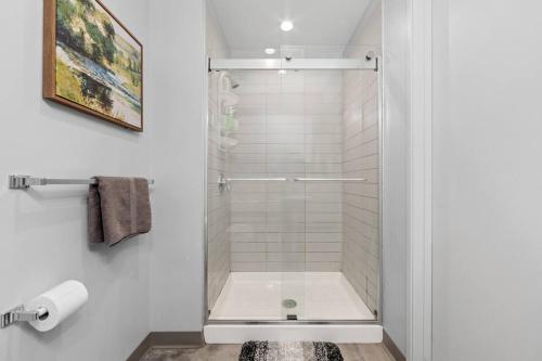 a shower with a glass door in a bathroom at MDRN Escape with Natural Light Wi-Fi Gym Parking in Cleveland