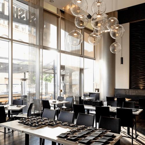 a dining room with tables and chairs and chandeliers at Luxury Highrise Living Downtown LA in Los Angeles
