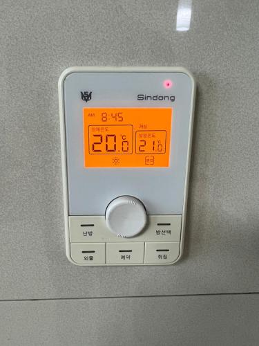 an electronic clock on the wall of an airplane at AwesomeSuwon 주재원 장기거주 할인 in Suwon