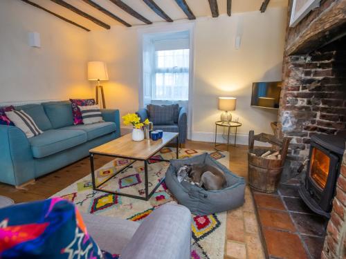 a living room with a couch and a fireplace at 3 Bed in Docking 43950 in Docking