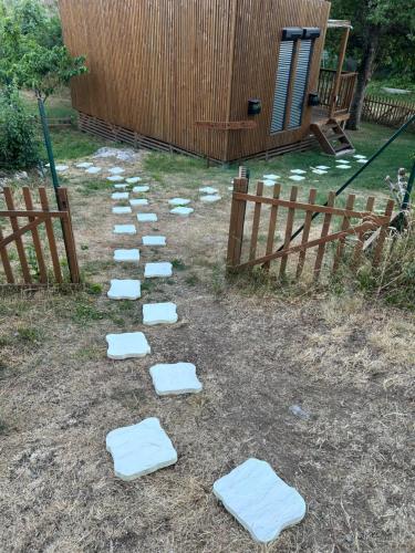 a row of stepping stones in a yard next to a fence at Lou Mazet Séjour en Aubrac in Saint-Laurent-de-Muret