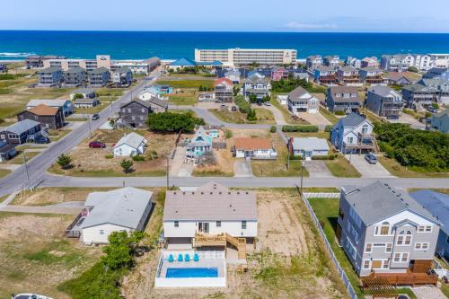 an aerial view of a neighborhood with houses and the ocean at Coles Cabana in Kill Devil Hills