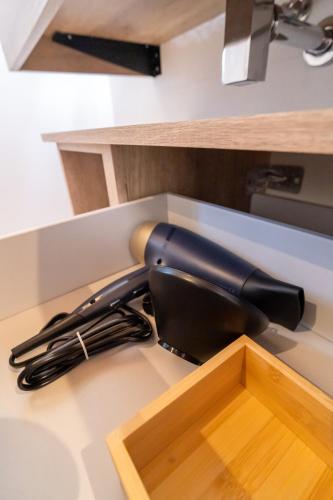 a black hairdryer sitting on a kitchen counter at La Casa di Peppolo in Randazzo