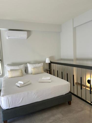 a bedroom with a bed with two towels on it at ALTHEA luxury suites and apartments in Plataria