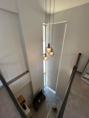 a room with a staircase and two lights at ALTHEA luxury suites and apartments in Plataria