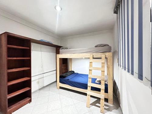 a bedroom with a bunk bed and a ladder at Suite#11 Cerca de Auto. Mex-Qro. in Cuautitlán Izcalli