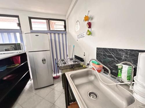 a kitchen with a sink and a refrigerator at Suite#11 Cerca de Auto. Mex-Qro. in Cuautitlán Izcalli