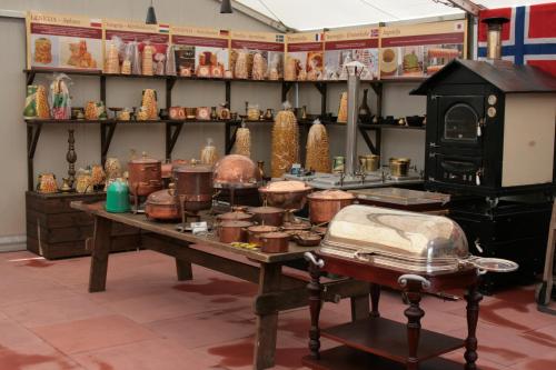 a table with pots and pans and a stove at Sodyba Ignė in Druskininkai