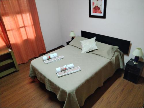 a bedroom with a bed with two trays on it at La Casa de los Viejos in Minas