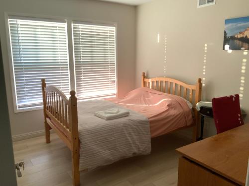 a small bedroom with a bed and two windows at 1 bedroom in a quiet neighborhood near the main street - Room B in Rowland Heights
