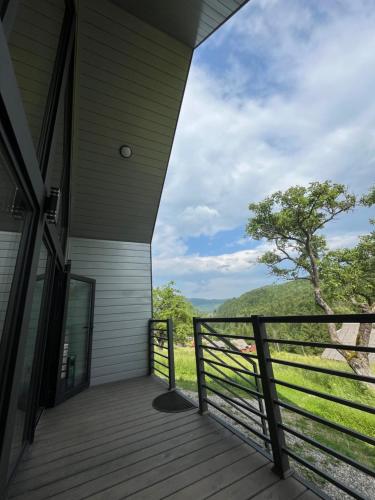 a porch of a house with a view of a tree at Котедж Mountain Hut in Yaremche