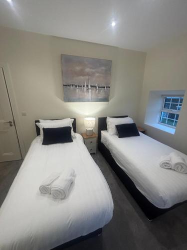 two beds sitting next to each other in a room at The Residence at Lough Key - Luxury by the Water in Knockvicar Bridge