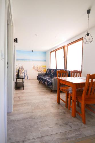 a bedroom with a bed and a table and chairs at Chatka in Stegienka