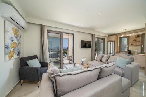 a living room with a couch and two chairs at Maera Apartments in Sami