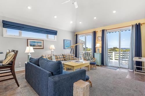 a living room with a couch and chairs and a table at Craven Haven in Nags Head
