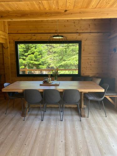 a dining room with a large wooden table and chairs at La Torre d' Espinalbet in Castellar del Riu
