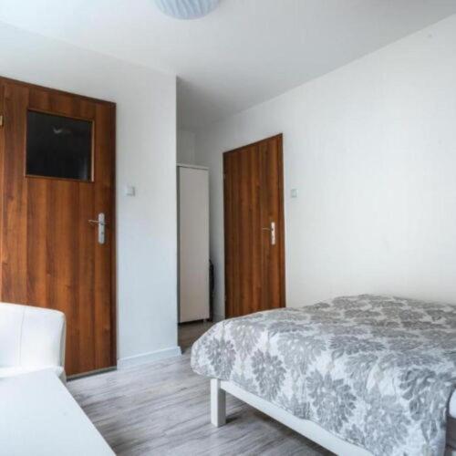 a bedroom with a bed and a wooden cabinet at Pablo in Niechorze