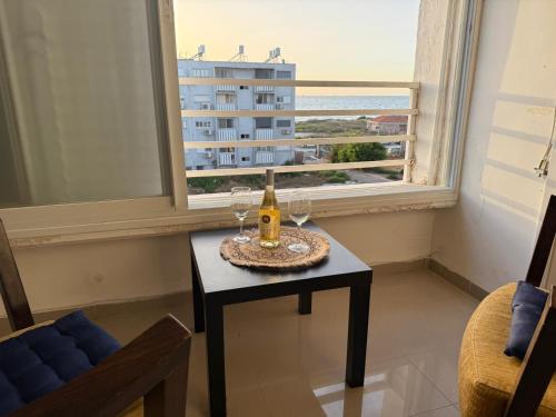 a room with a table with wine glasses and a window at אירוח סמוך לים התיכון in Haifa