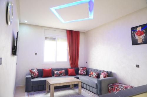 a living room with a couch and a window at 2 Voies Résidence in Dakhla