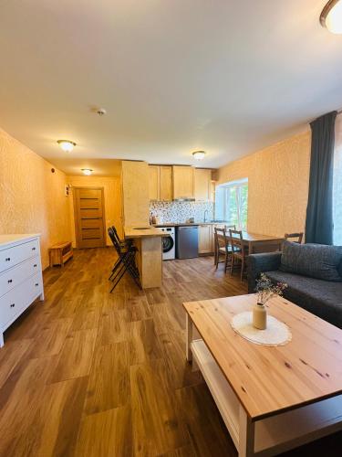 a living room with a couch and a table at Rožu namu apartamenti 4 in Kuldīga