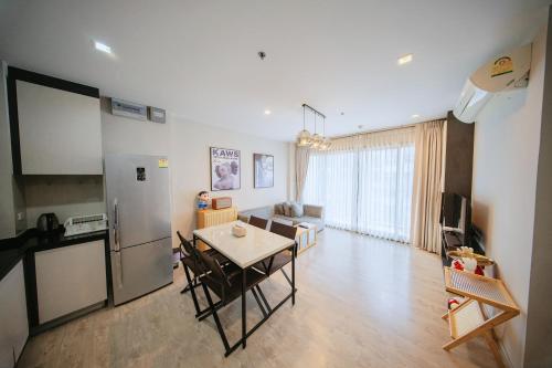 a kitchen and living room with a table and a refrigerator at THE BASE Sea View Holiday inn Central Pattaya in Pattaya