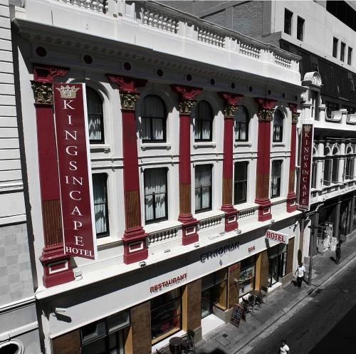 a red and white building with a sign on it at Kings in Cape in Cape Town