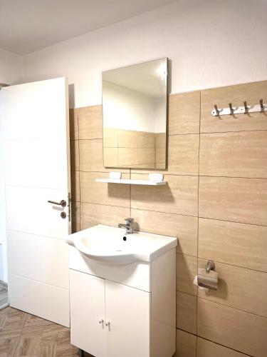 a bathroom with a white sink and a mirror at Vivien Chalet in Victoria