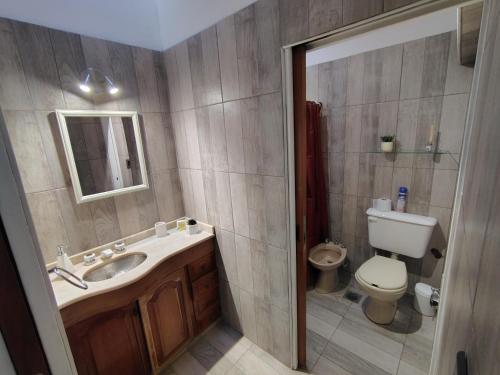 a bathroom with a sink and a toilet at Casa Milo in Mendoza
