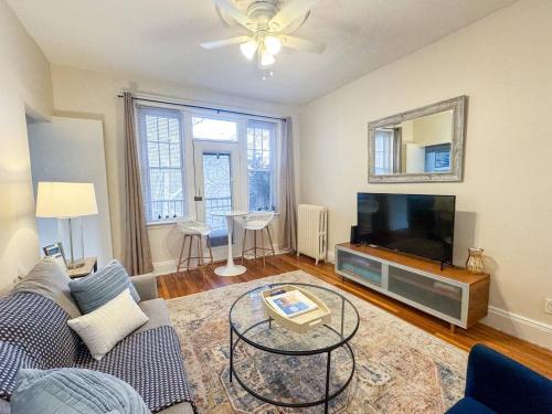 a living room with a couch and a flat screen tv at 2 bed, in unit laundry, Boston College, balcony in Boston