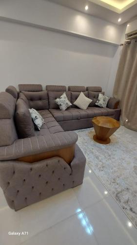 a living room with a brown couch and a table at Eamar tower 2 in Tanta